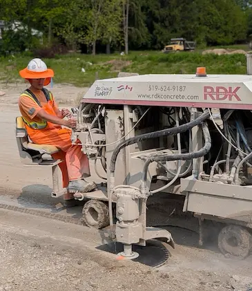 Man on a Curb Cutting Machine